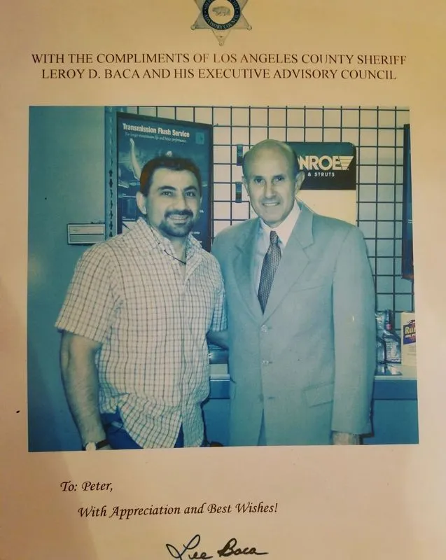Framed photo of two men at a formal event, one in a suit, with an appreciation message above and below.
