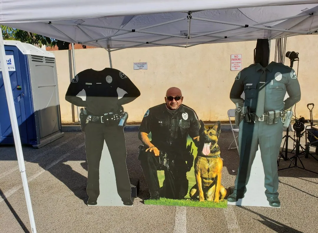 A cardboard cutout of a police officer and his dog