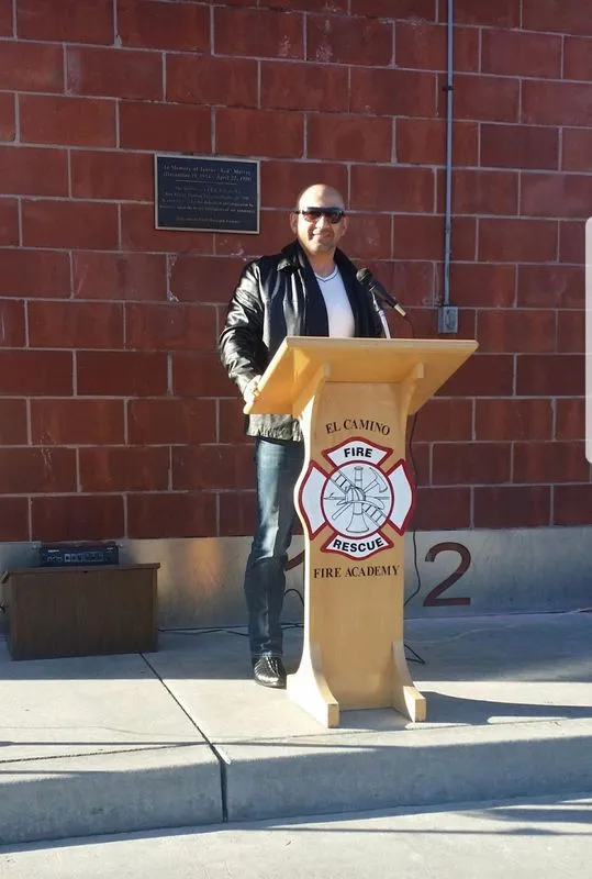 A man stands at a podium with the number 2 on it